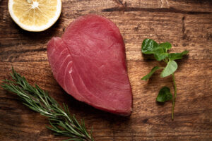 fresh red tuna fillet, for steak, raw, top view, on a cutting board, no people,